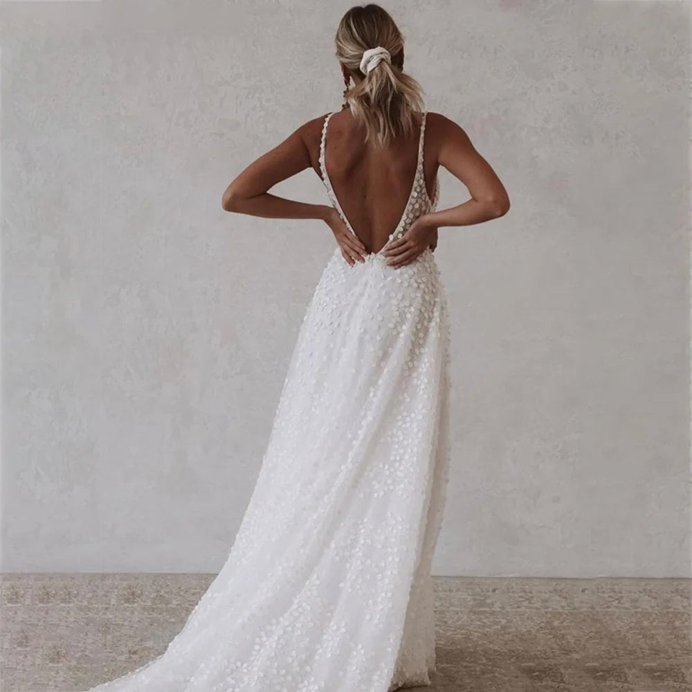 Back view of a bride wearing a Deep V-Neck Wedding Dress with Pockets and Spaghetti Straps