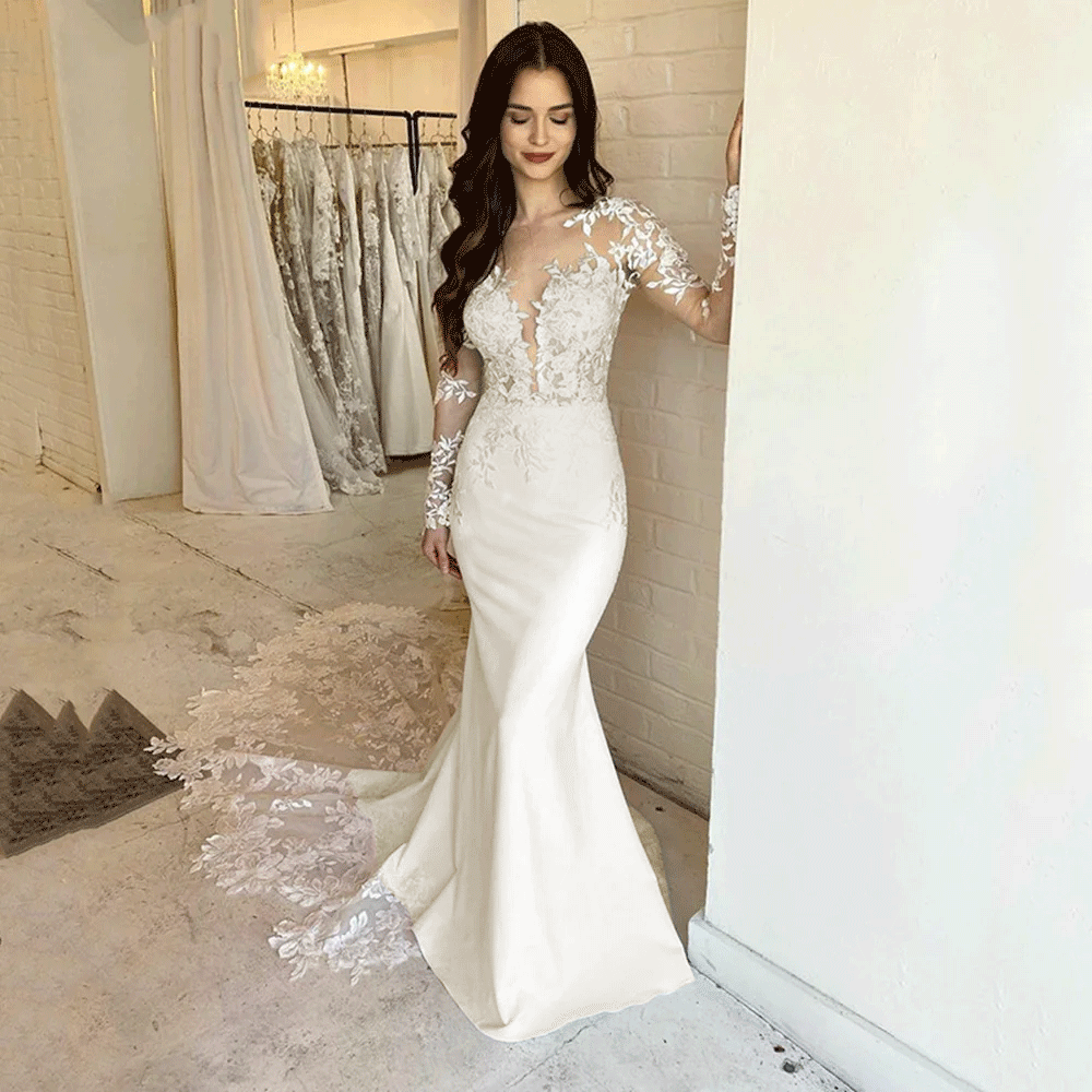 Bride wearing an ivory Elegant Lace Mermaid Appliqued Dress with Long Sleeves