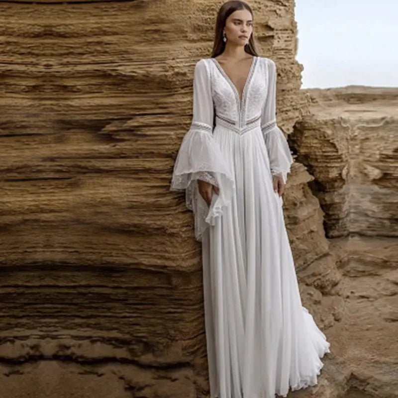 front view of bride on beach wearing a white Long Backless Wedding Gown with Deep V-Neck and Flare Sleeves