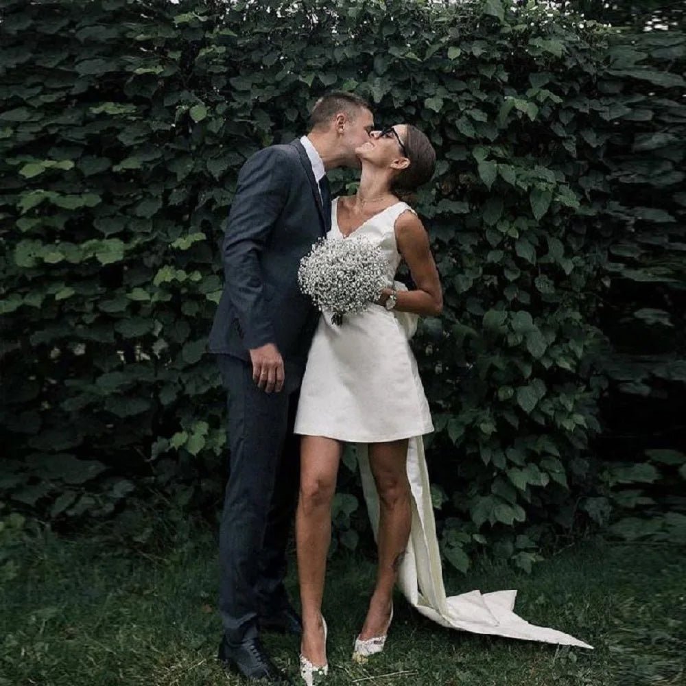 married couple outside wearing a Short Boho V-Neck Wedding Dress with Large Bow and Detachable Train