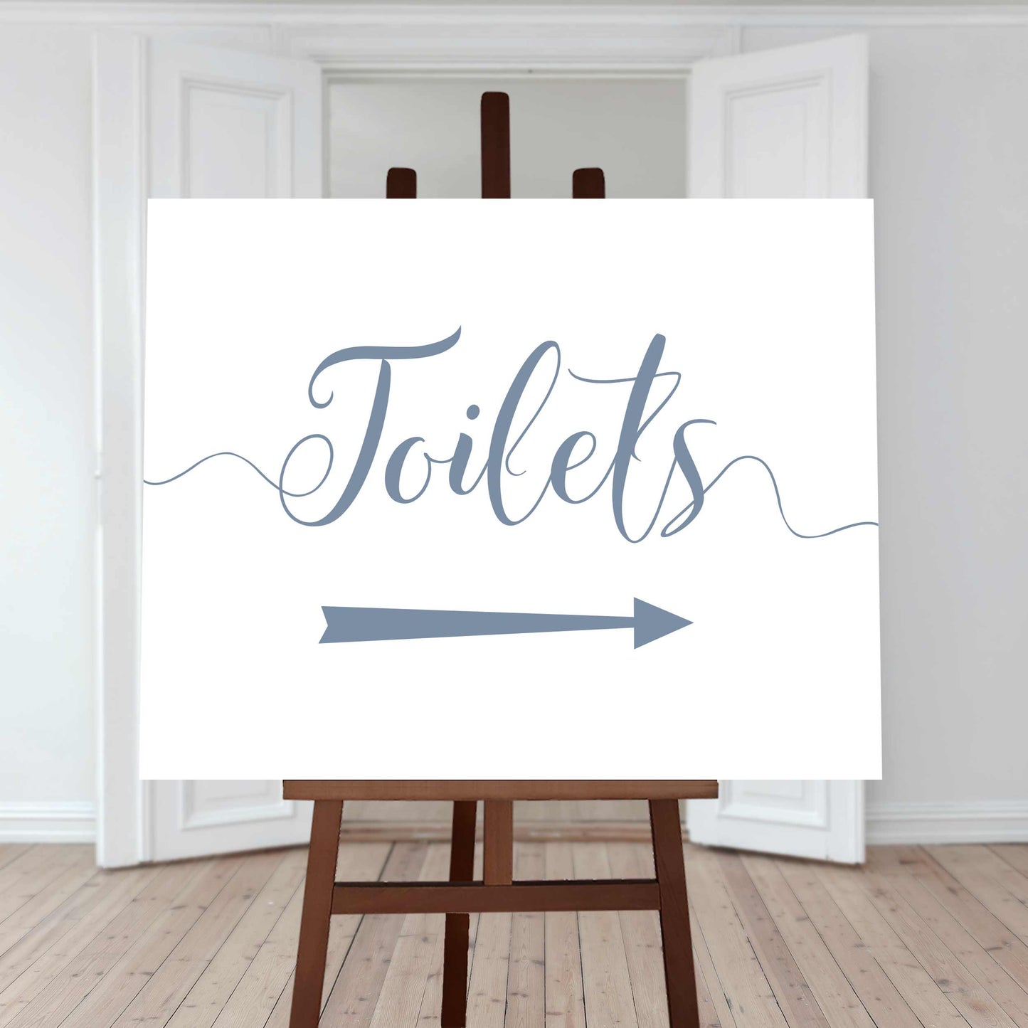 baby blue wedding toilet directions sign with an arrow pointing right