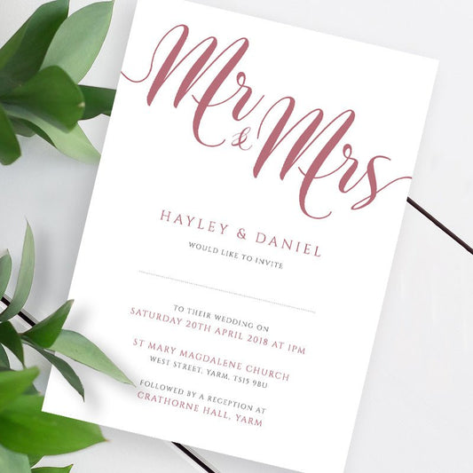 blush pink wedding invitation template on a white table