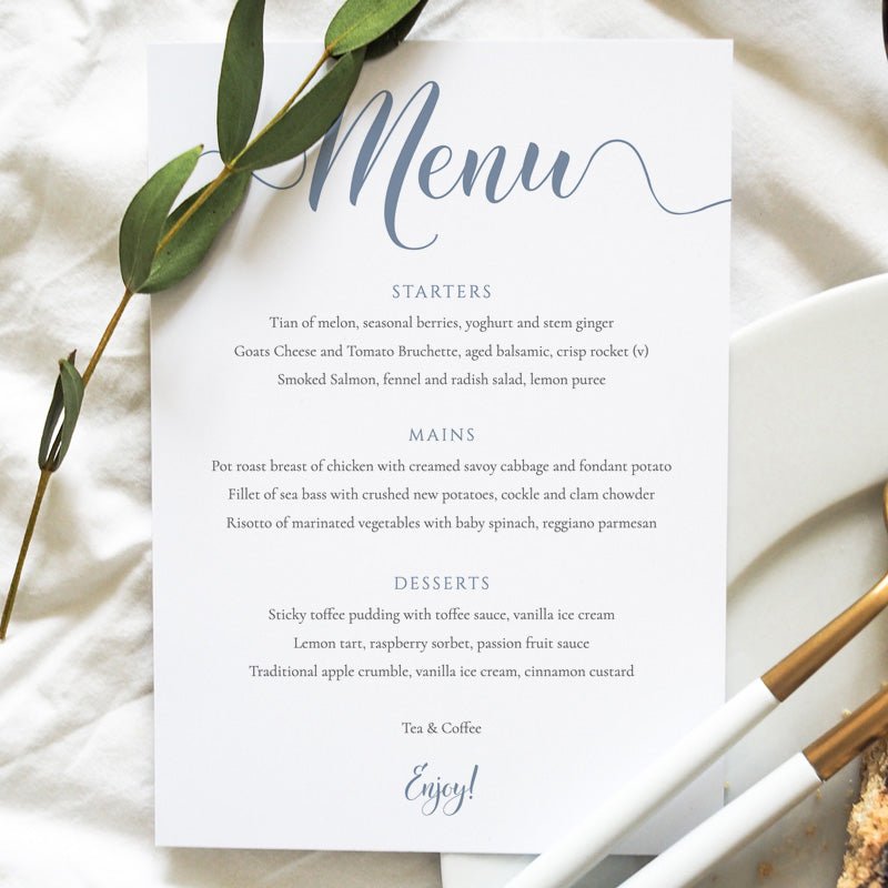 dusty blue dinner menu printed on card on a wedding table