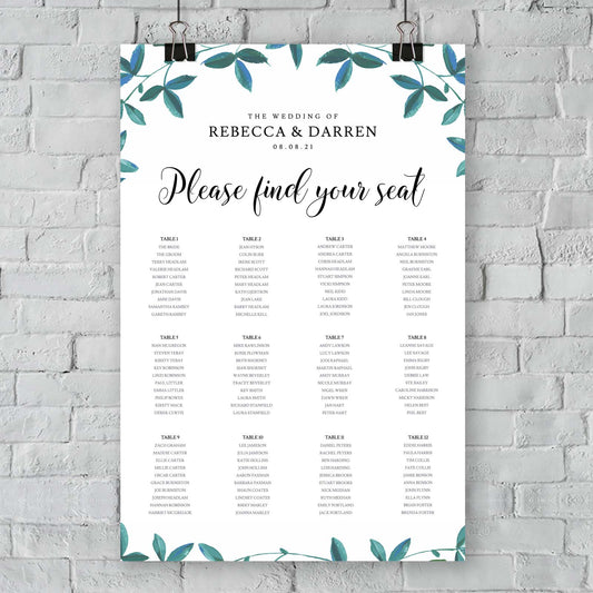 seating chart with 12 tables and green foliage border hanging from an exterior wall