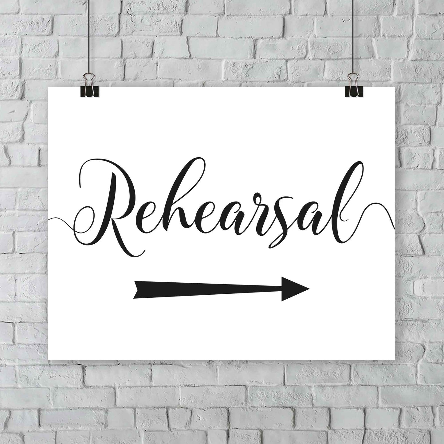 printed wedding rehearsal sign at an outdoor wedding