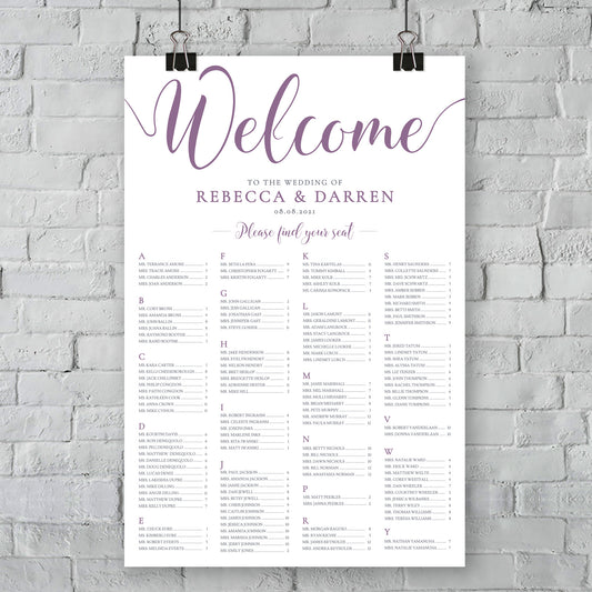 large print of purple wedding seating chart on wall