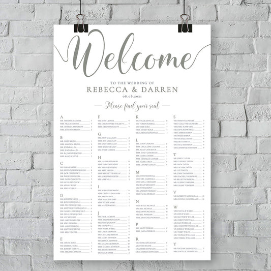 large sage green table plan on white brick wall