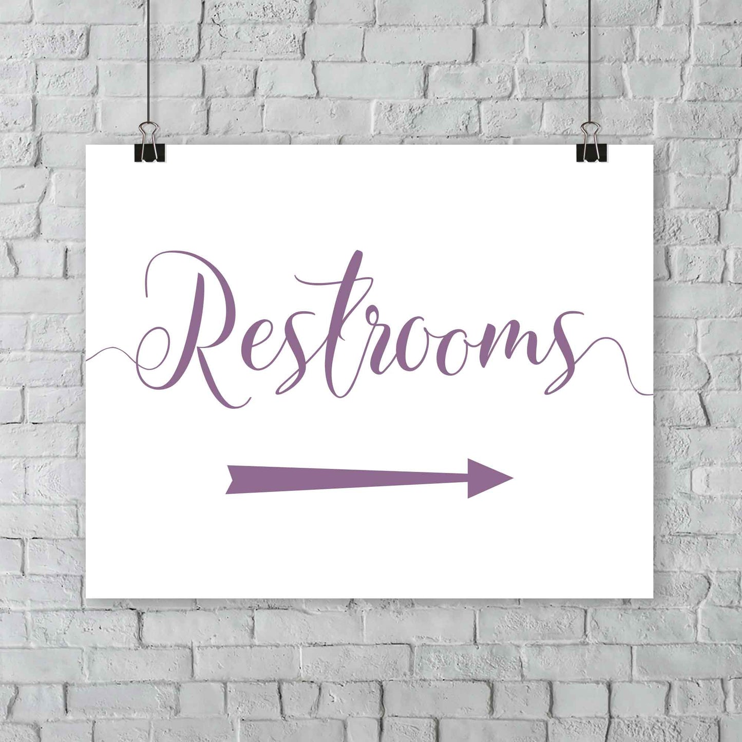 lavender purple wedding restrooms arrow signage hanging from a wall