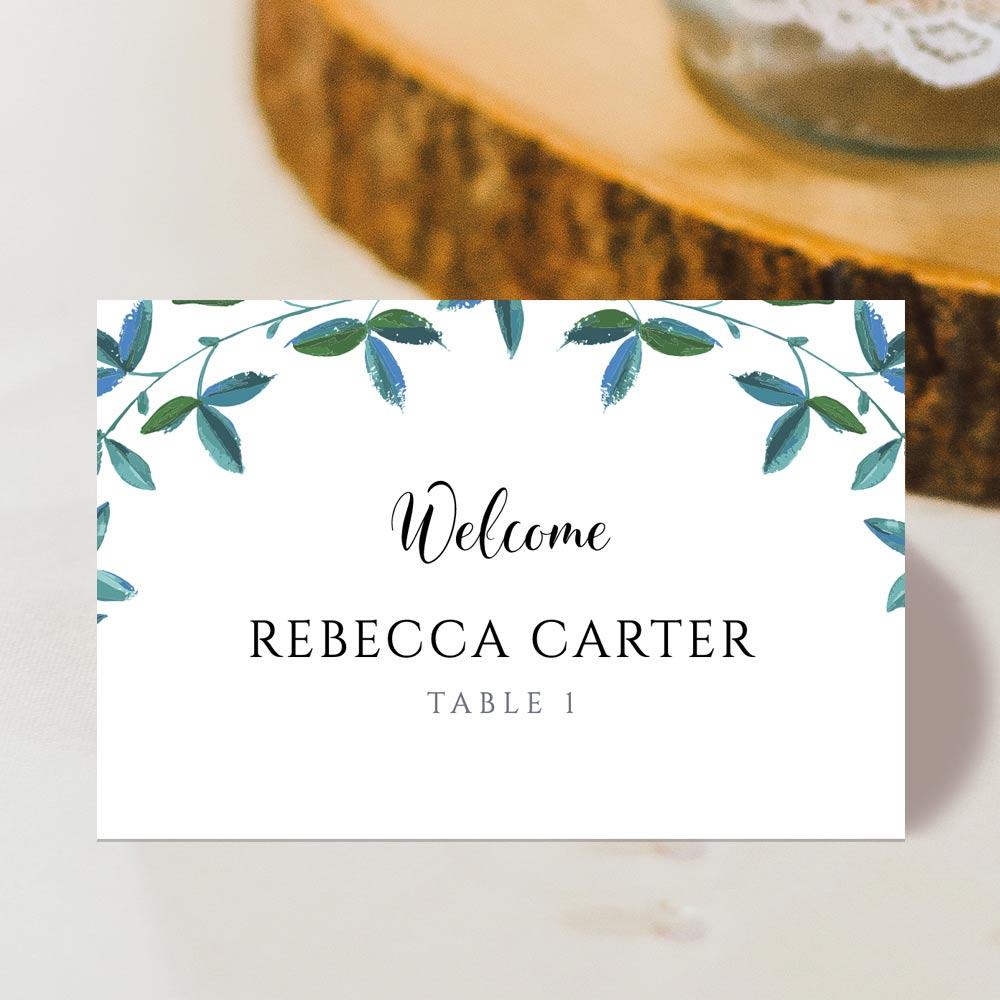 front view of an outdoor wedding place card with a green leaf border