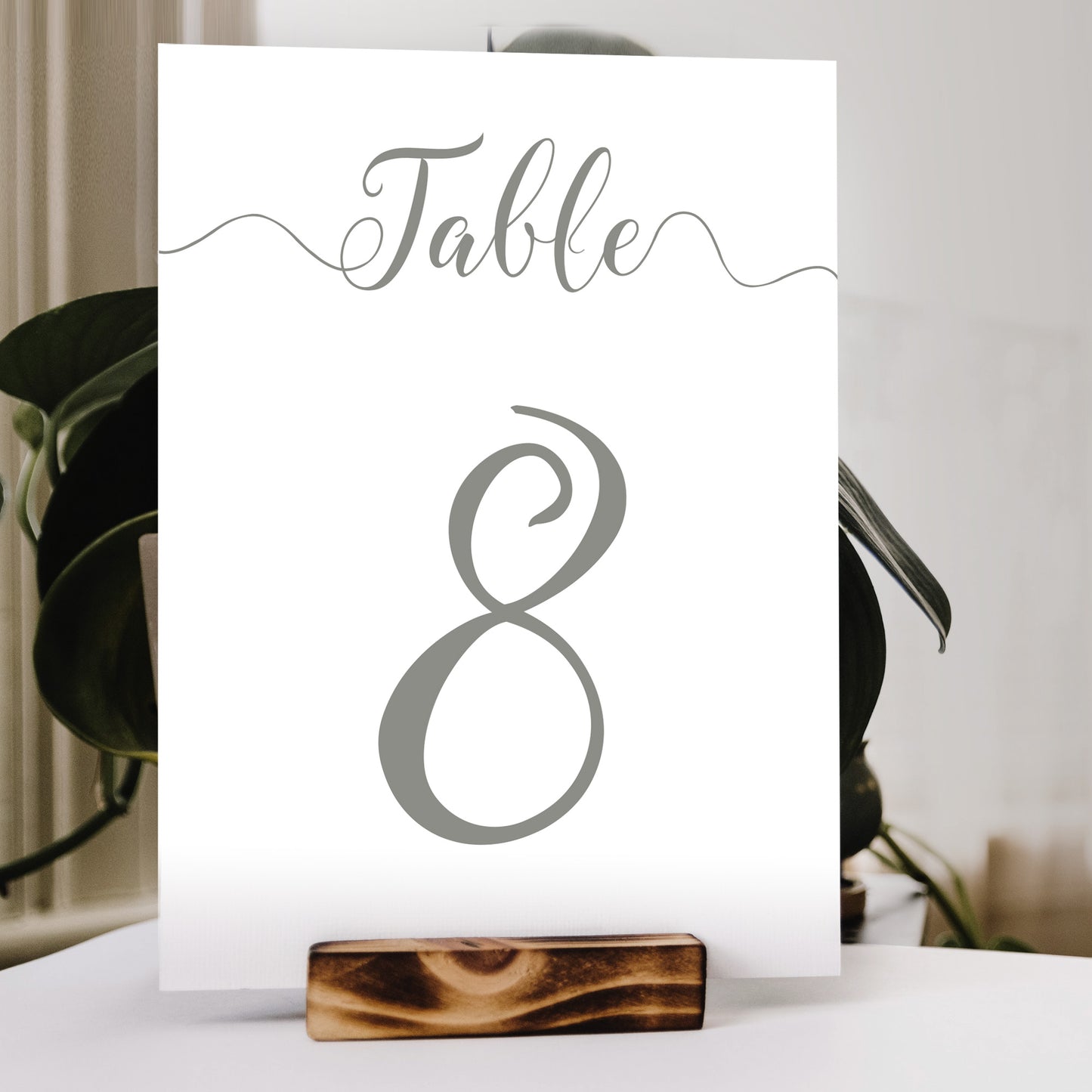 pastel green number print in a wooden stand at a wedding