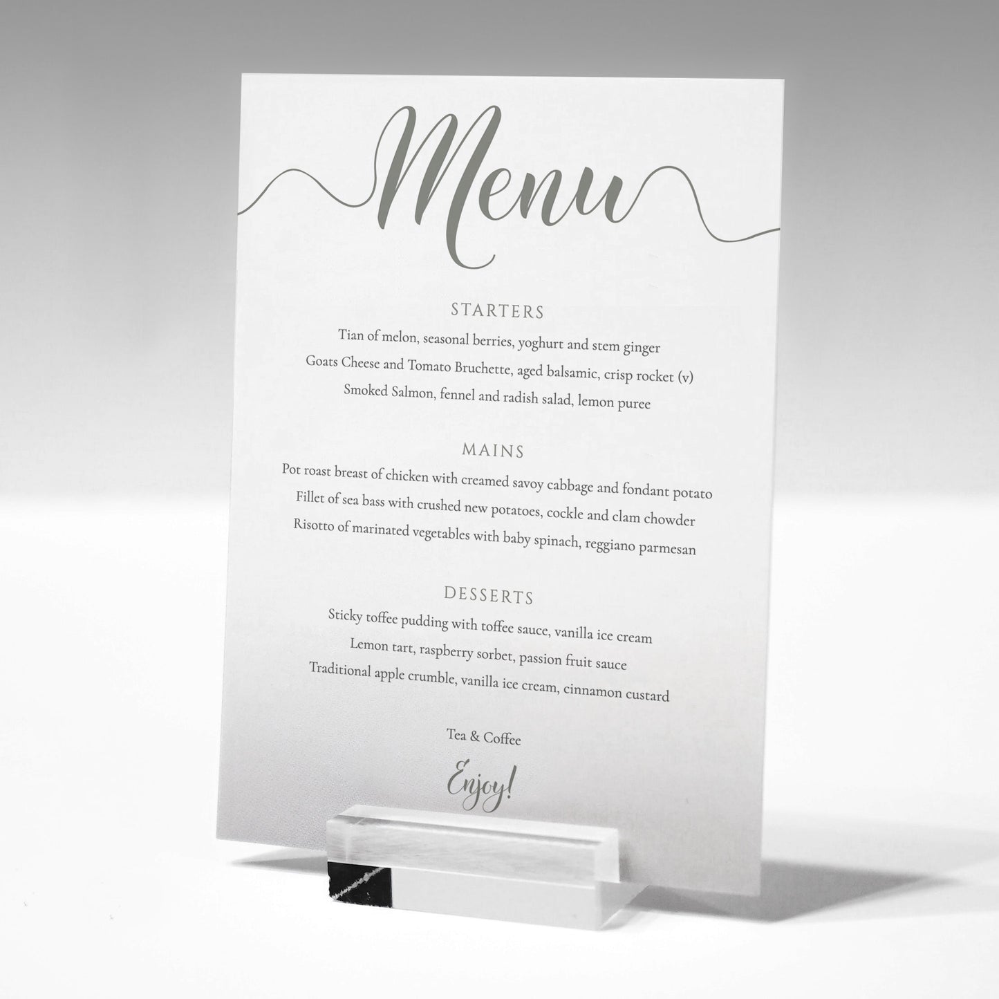 pastel green wedding menu card in a glass stand