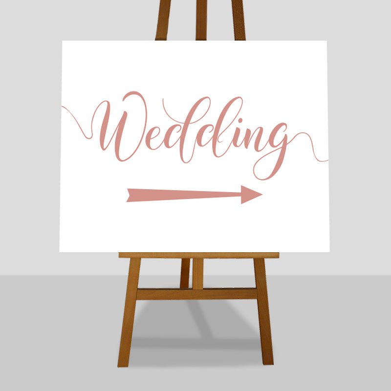 peach wedding arrow sign on easel