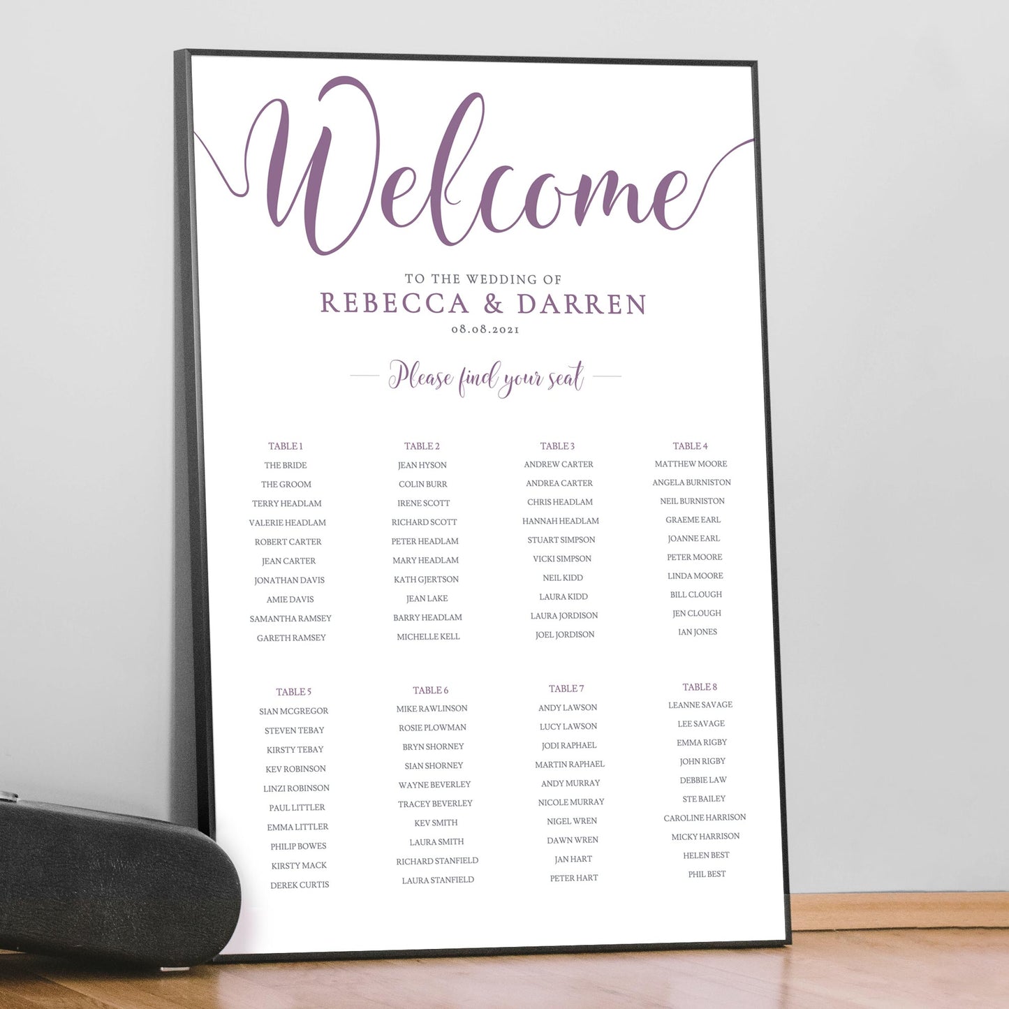 printed purple seating chart in large black frame