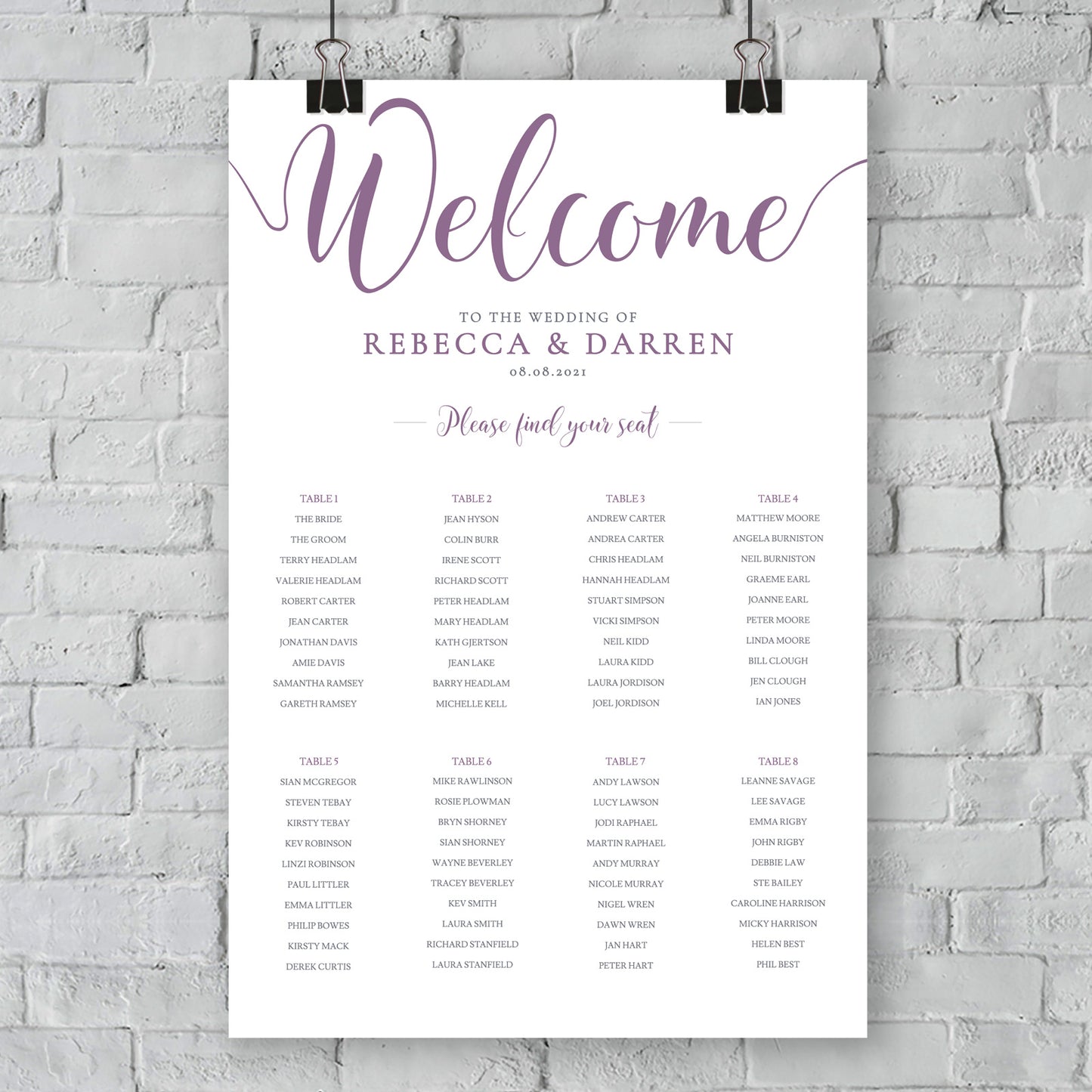 purple seating chart on wall at outdoor wedding