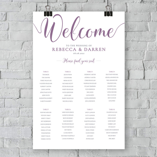 purple seating chart on wall at outdoor wedding