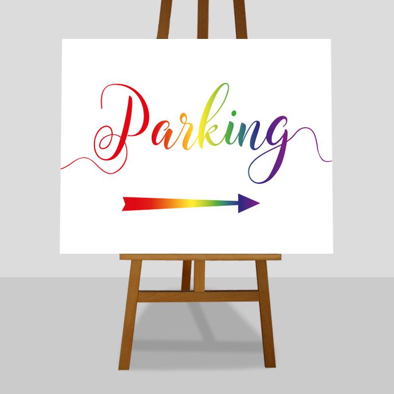 Printed car park directions sign in rainbow colours