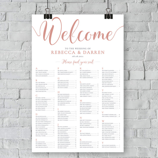 rose gold seating chart on a brick wall