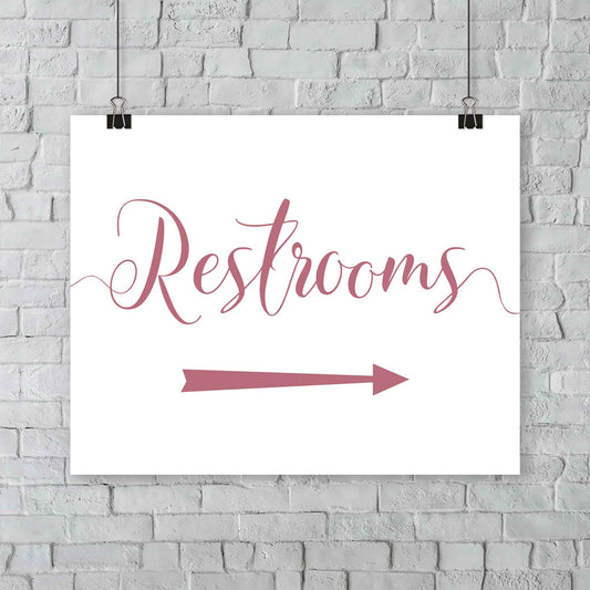 rouge pink wedding restrooms arrow signage hanging from a wall