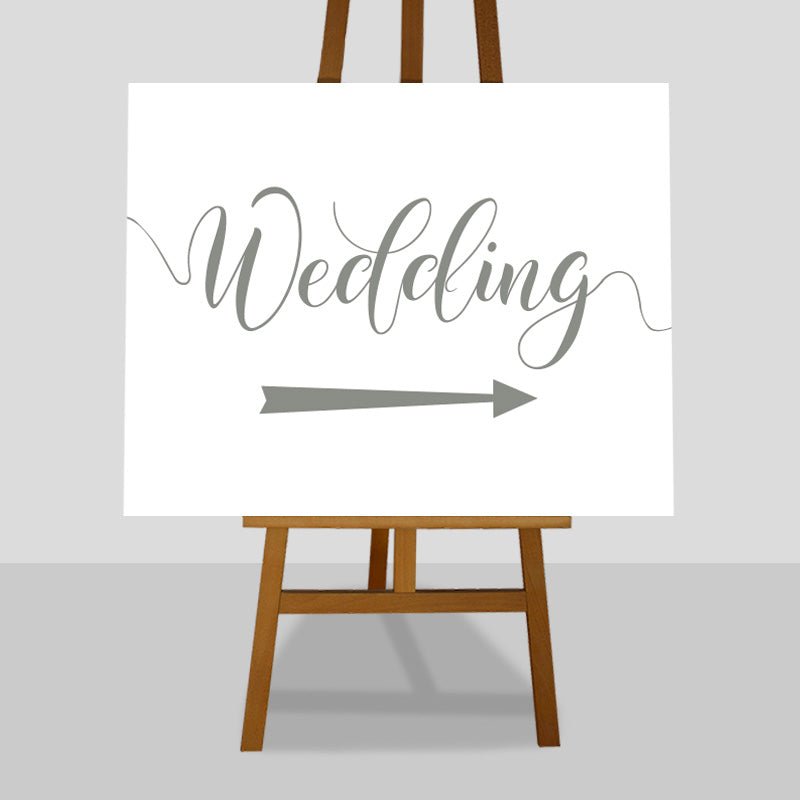 sage green wedding arrow sign on easel
