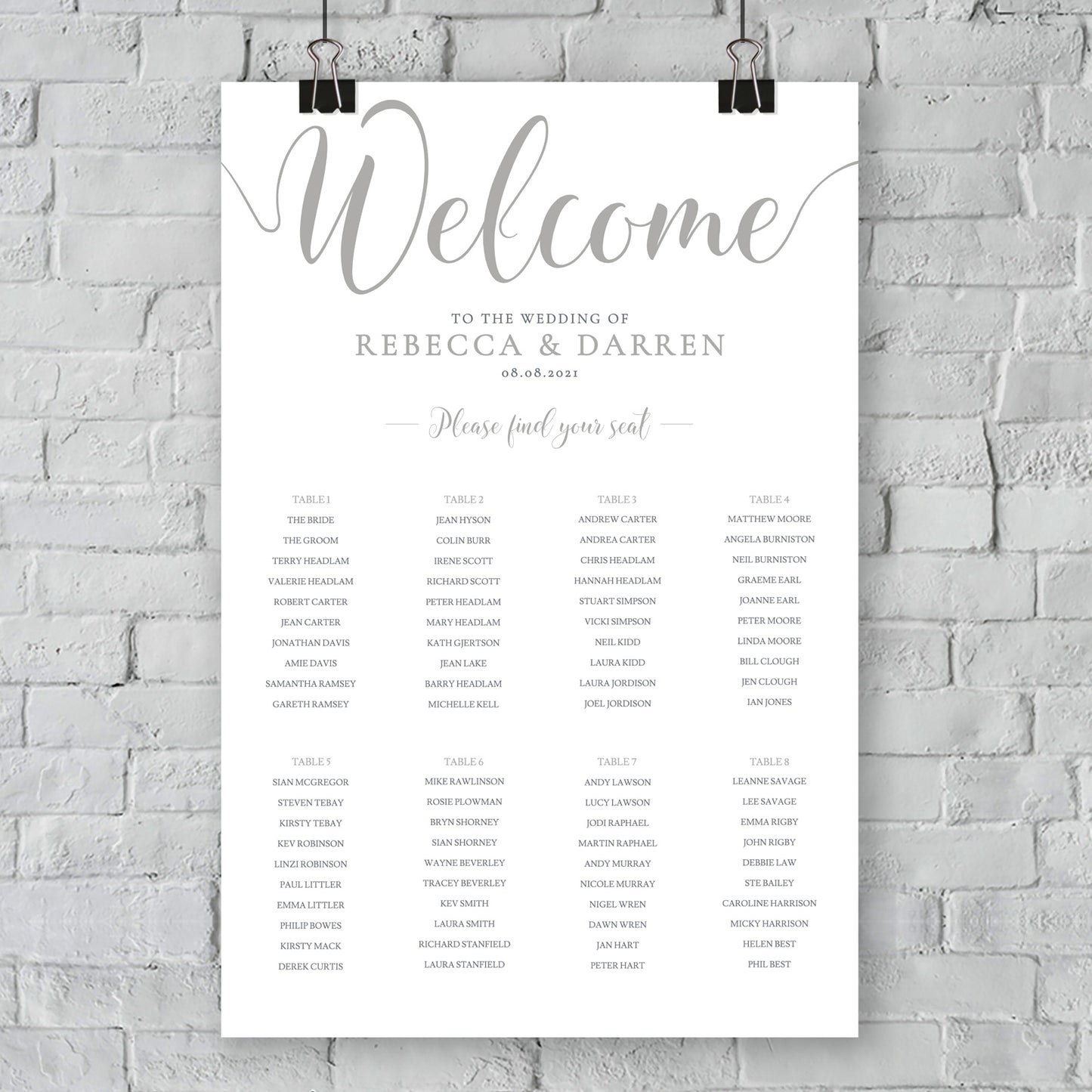 silver seating chart on wall at an outdoor wedding