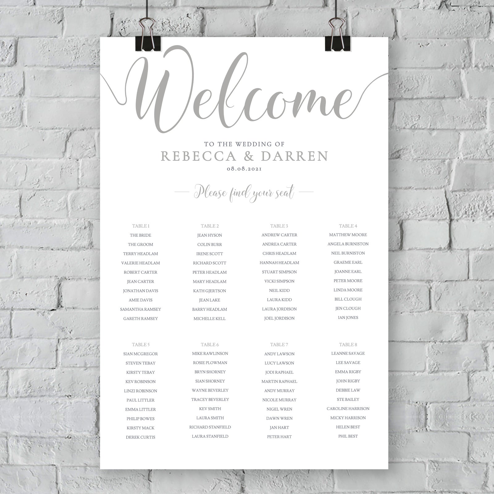 silver seating chart on wall at an outdoor wedding