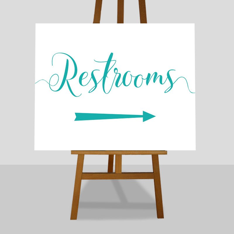 teal wedding restrooms arrow sign on an easel