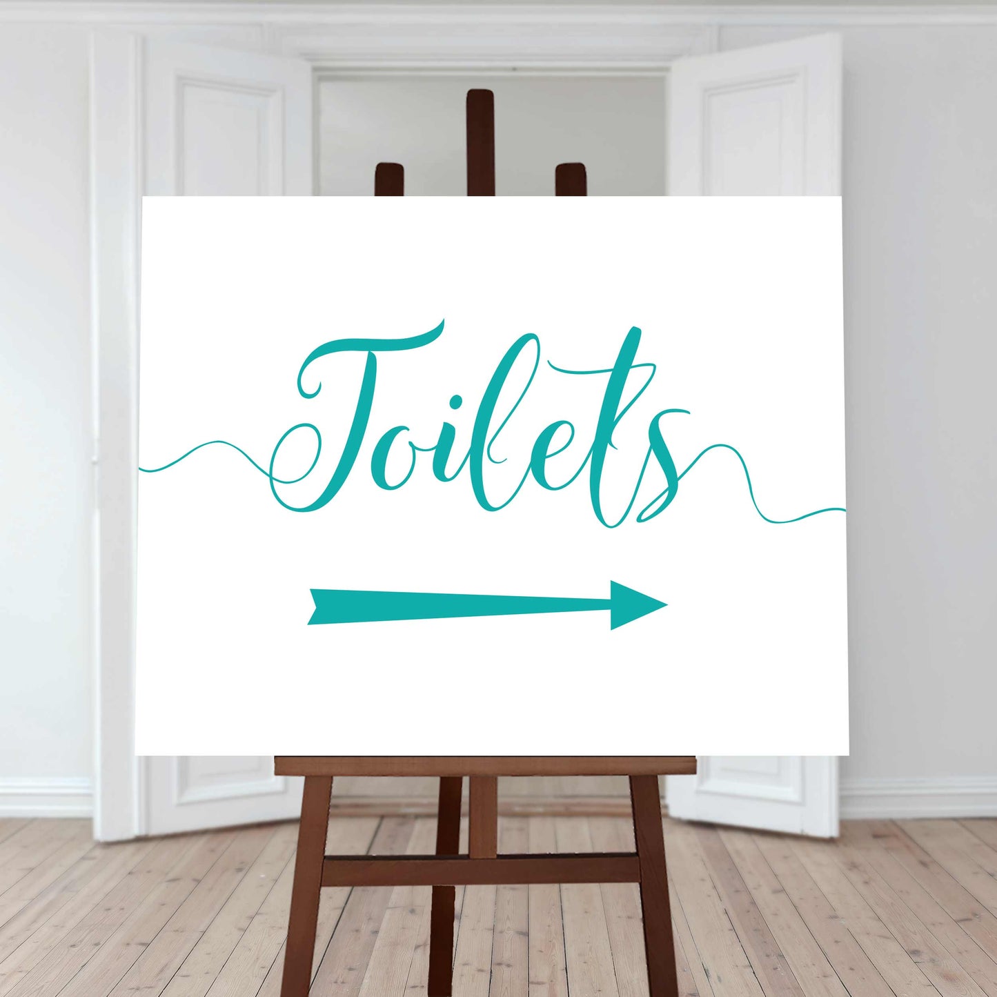 teal wedding toilet directions sign with an arrow pointing right