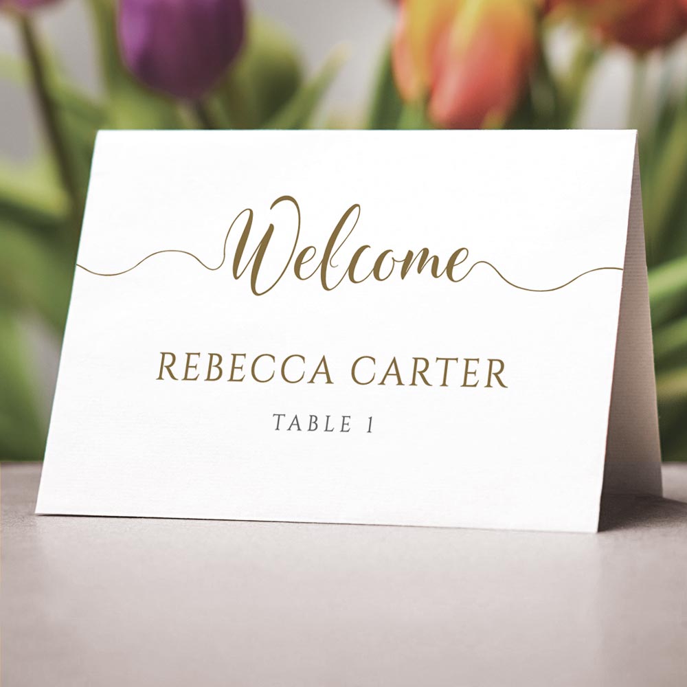 gold folded place cards on wedding table