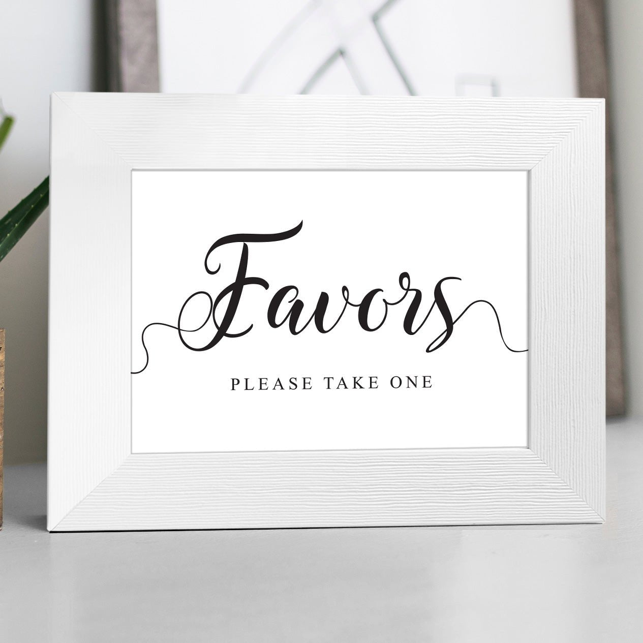 Display the Wedding Favors Sign - Instant Download in a white photo frame with elegant black script reading Favors, please take one—ideal for your wedding favor table. Instantly download the PDF for easy setup.
