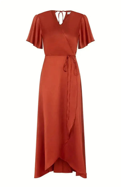 Burnt orange bridesmaid dress with a tie waist on a white background