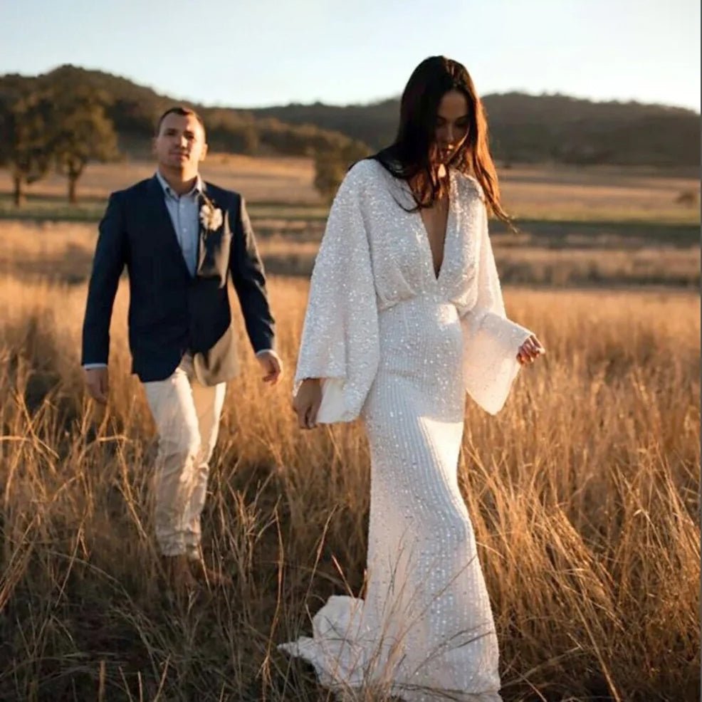 Bride wearing Luxury Long Sheer Sleeve Deep Backless Wedding Dress with groom in a field