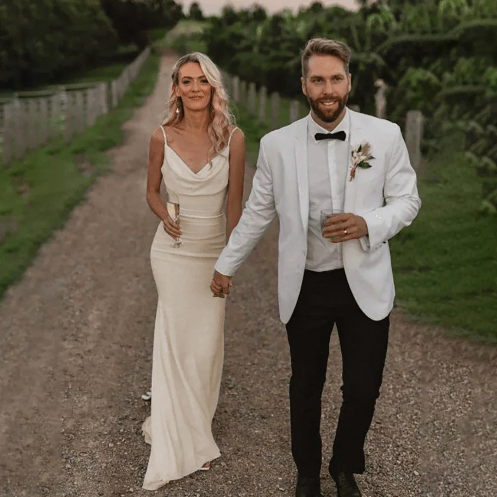 Bride wearing an ivory Elegant Satin Mermaid Wedding Gown with Spaghetti Straps