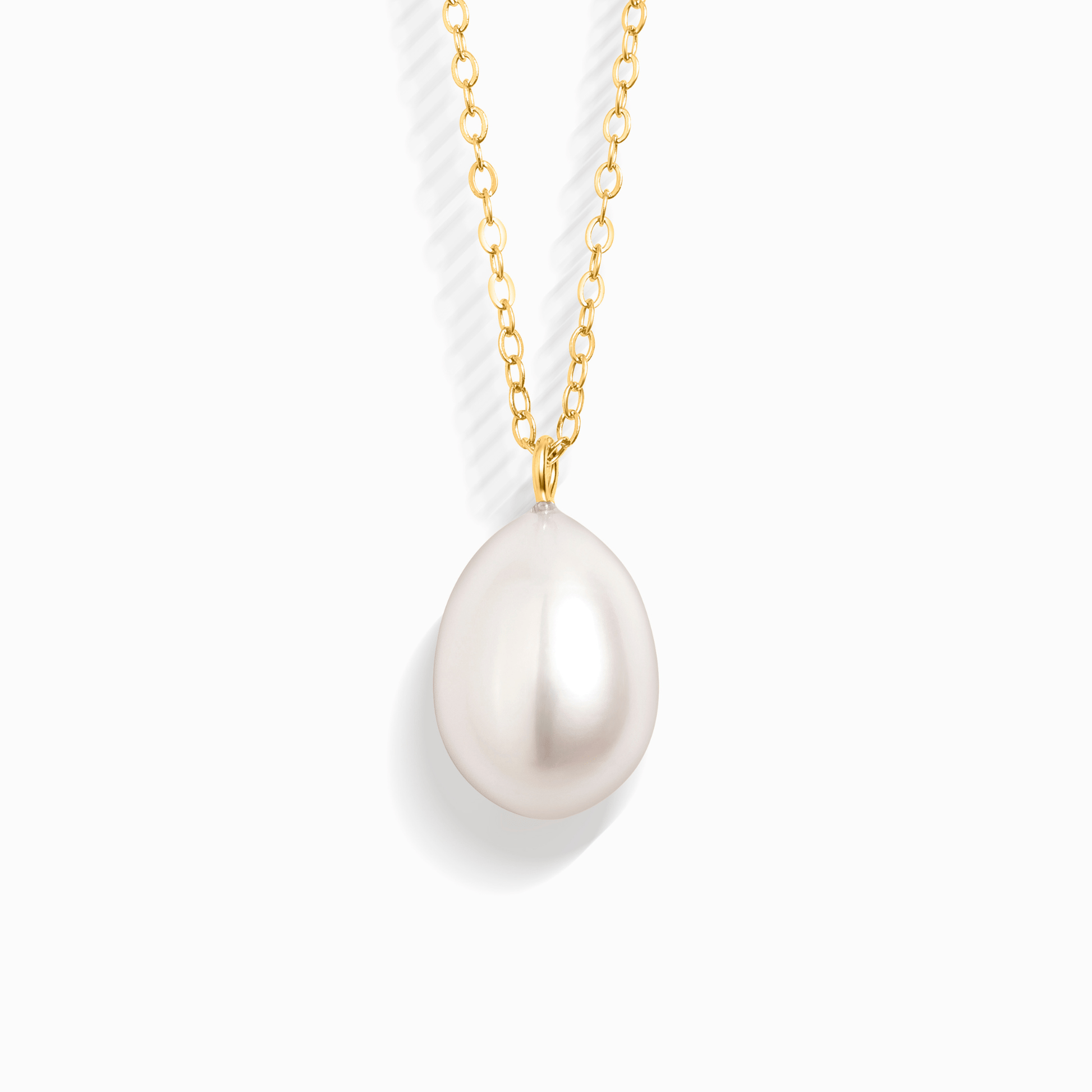 A single pearl pendant on a delicate gold chain, isolated on a white background.