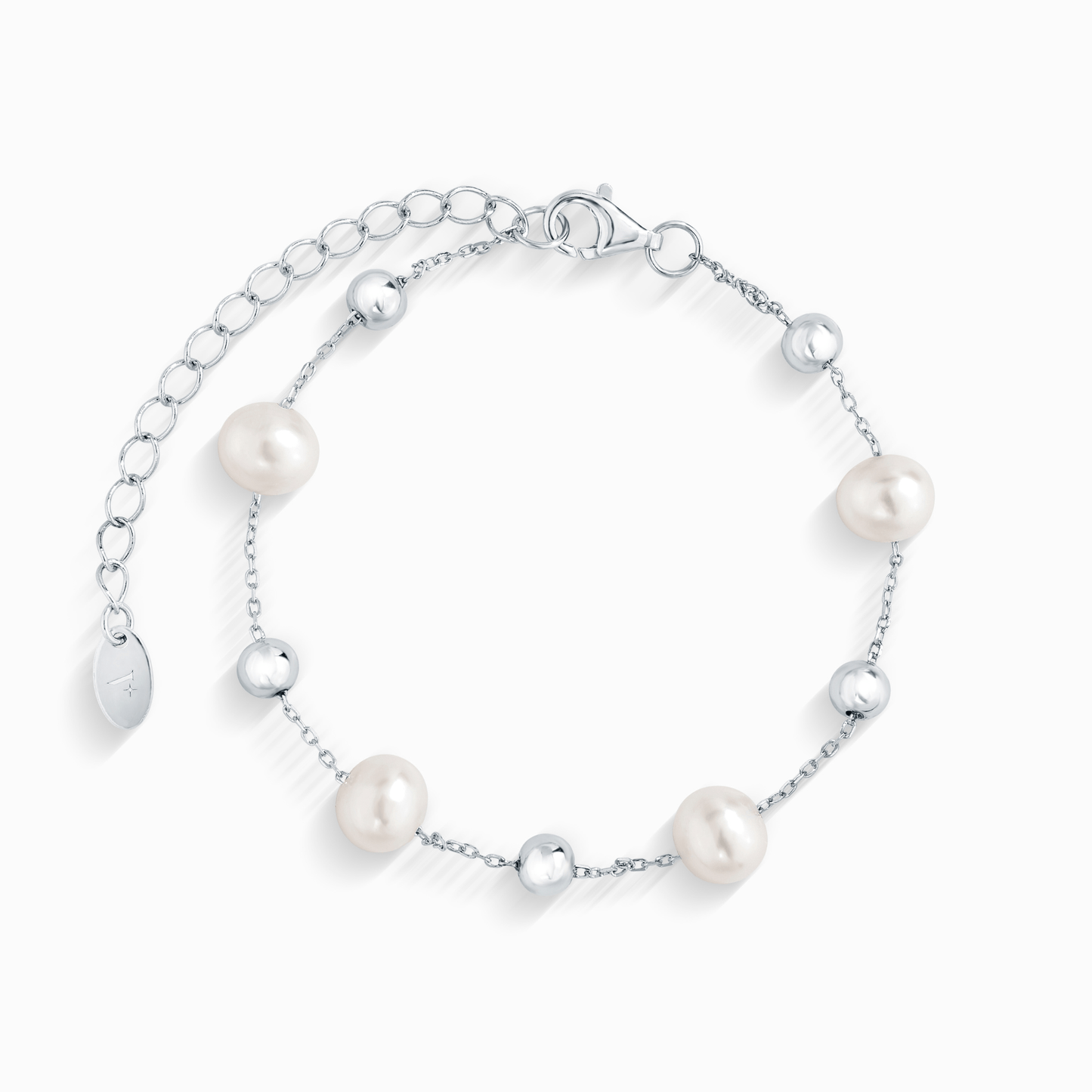A close-up of a silver chain bracelet with five evenly spaced white pearls and silver beads.