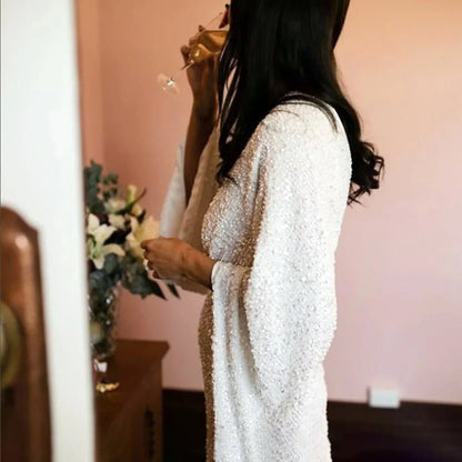 Side-view of bride in a Luxury Long Sheer Sleeve Deep Backless Wedding Dress