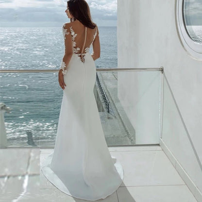 back view of a bride on a ship wearing a white Long Sleeve Mermaid Wedding Dress with Illusion Neckline and Lace Appliques