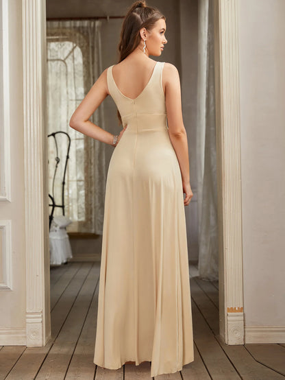 back view of lady wearing champagne colored split leg v-neck backless maxi bridesmaid dress