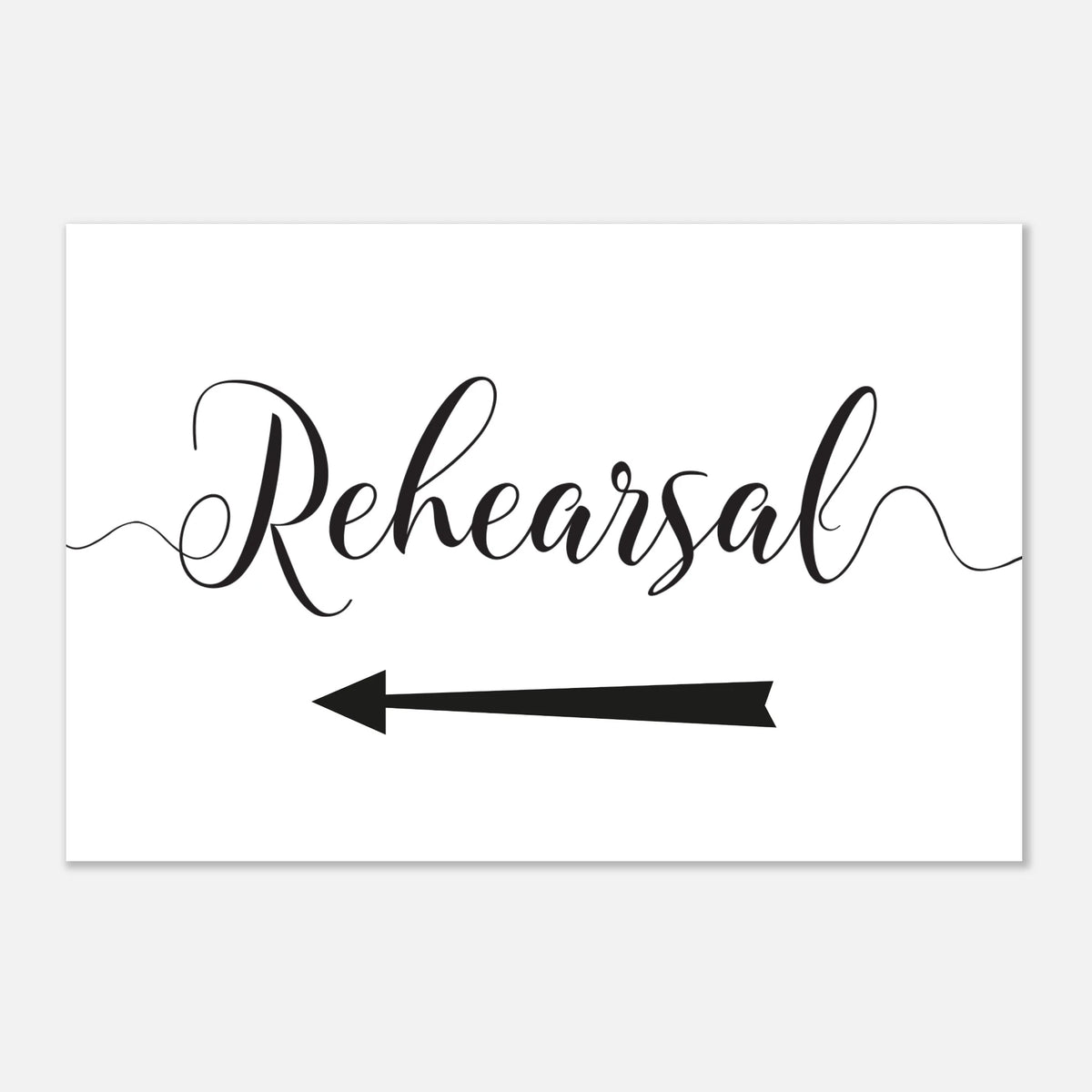 A white rectangular sign or card with the word 'Rehearsal' in black cursive script and a black left-pointing arrow below it, shown on a light gray background.