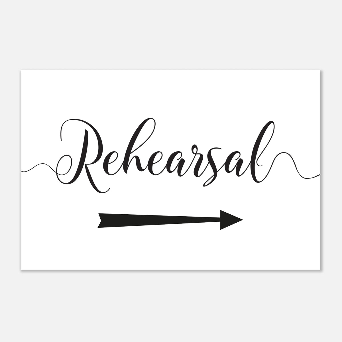A white rectangular sign or card with the word 'Rehearsal' in black cursive script and a black arrow pointing right, shown on a light gray background.