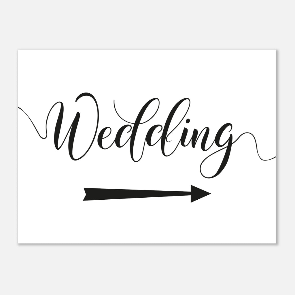 A white rectangular sign or card with the word 'Wedding' in black cursive script and a black arrow pointing right, shown on a light gray background.