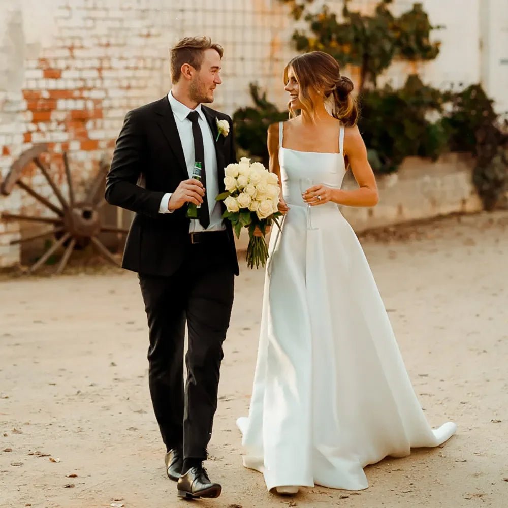 bride and groom holding flowers wearing Classic A-Line Pleat Vintage Wedding Dress