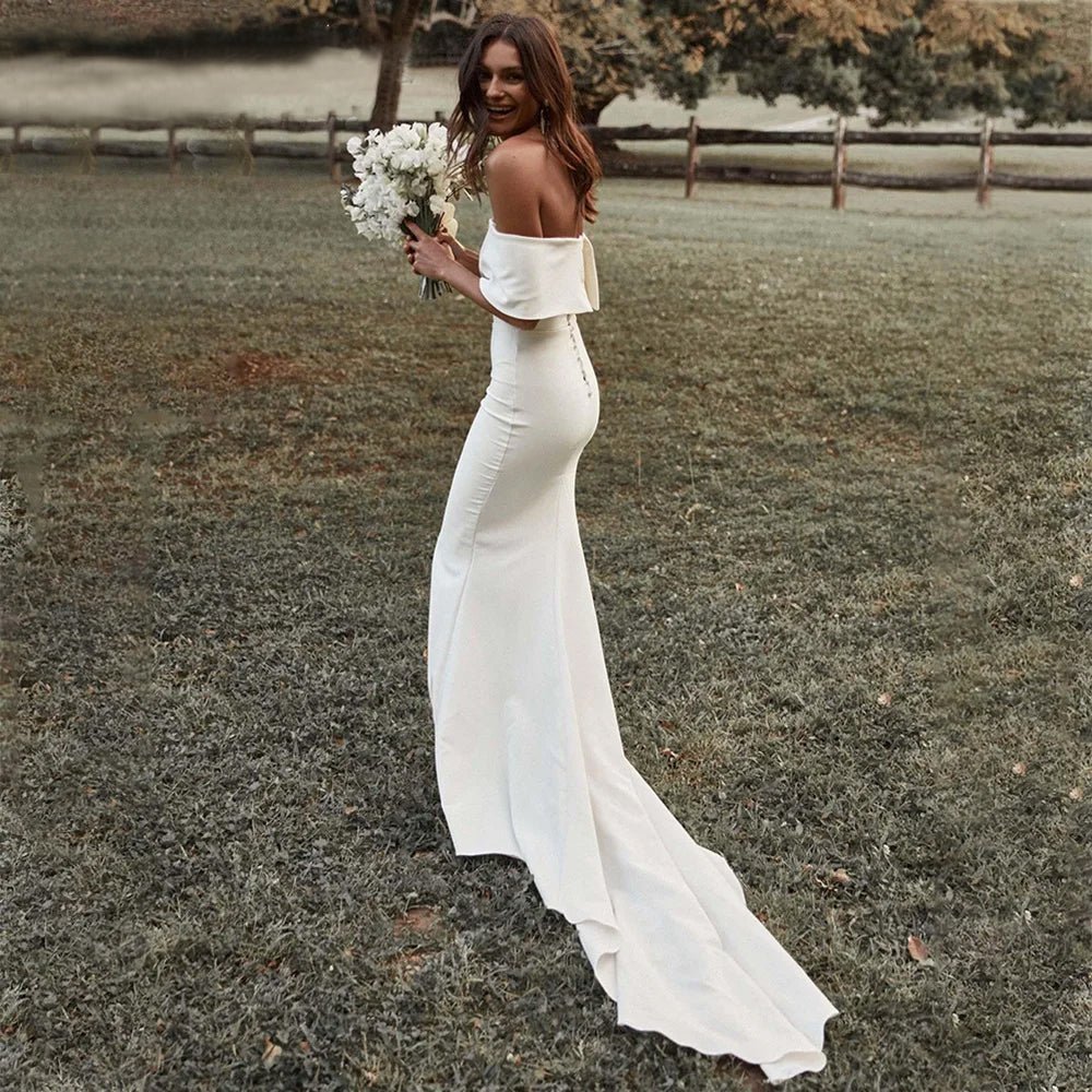 bride holding bouquet wearing Boho Off-the-Shoulder Mermaid Wedding Dress