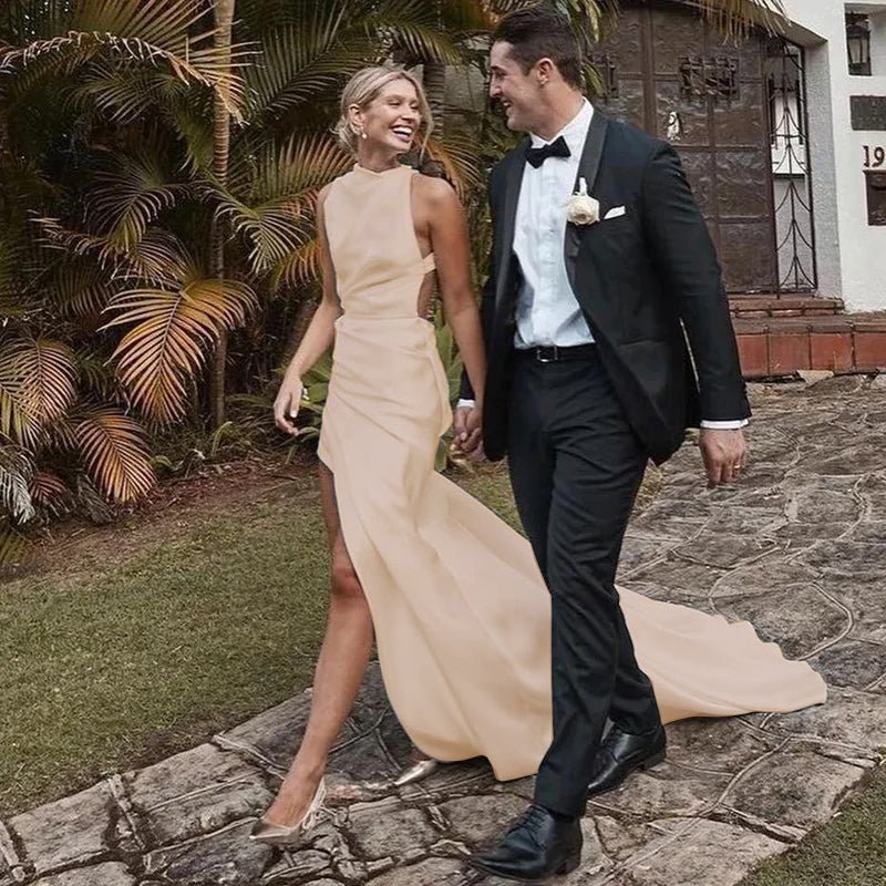 bride walking with groom wearing a High Side Slit Champagne Satin Mermaid Wedding Dress