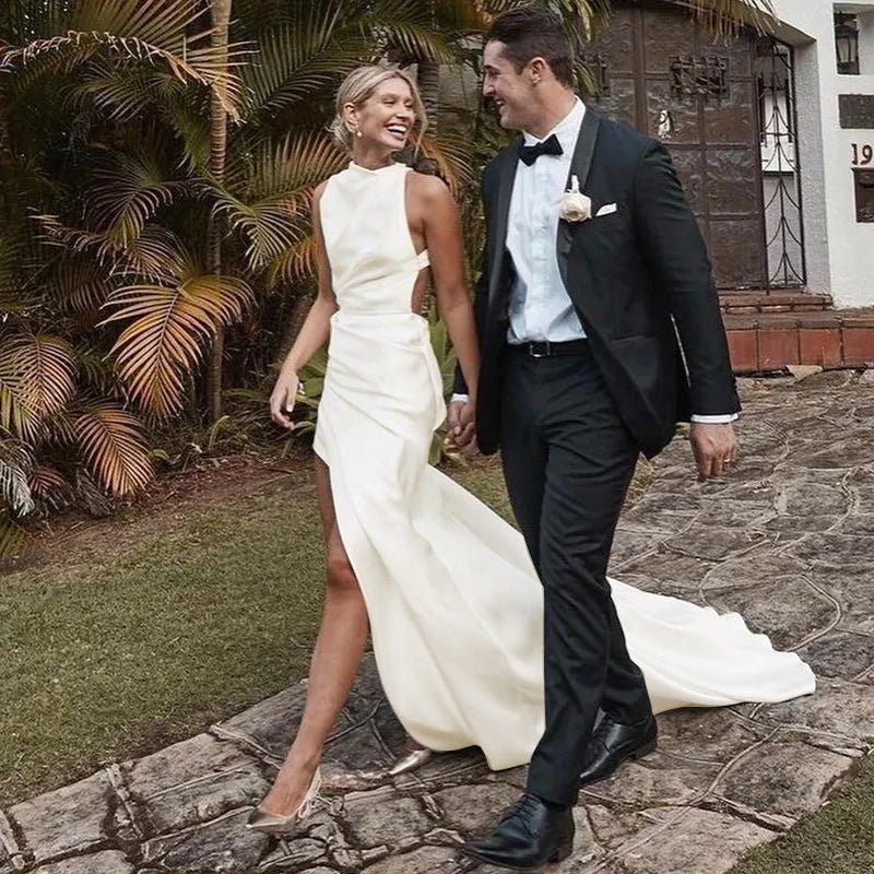 bride walking with groom wearing a High Side Slit Ivory Satin Mermaid Wedding Dress