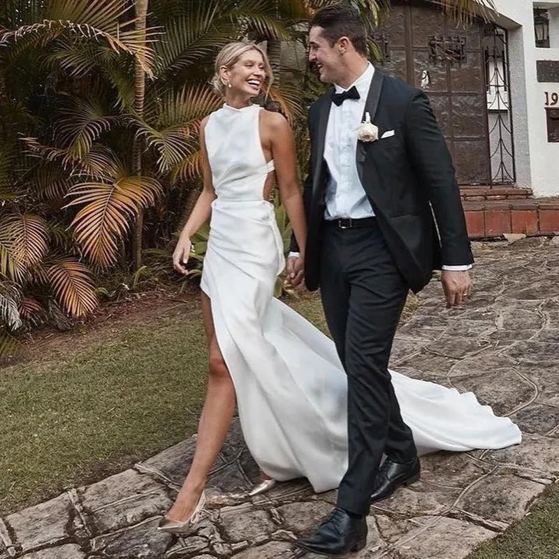 bride walking with groom wearing a High Side-Slit White Satin Mermaid Wedding Dress