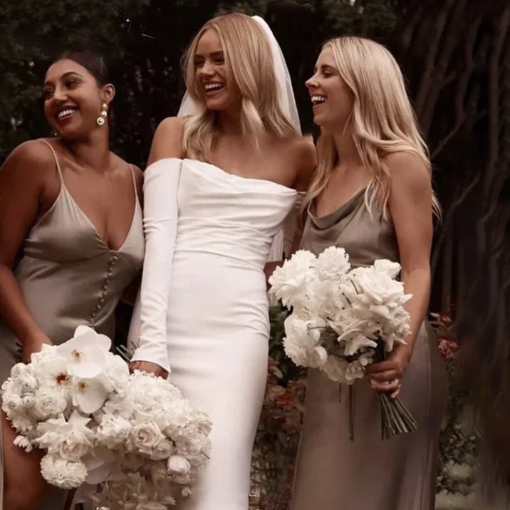 bride with bridesmaids wearing a white Off-the-Shoulder Modern Satin Mermaid Wedding Dress with Long Sleeves