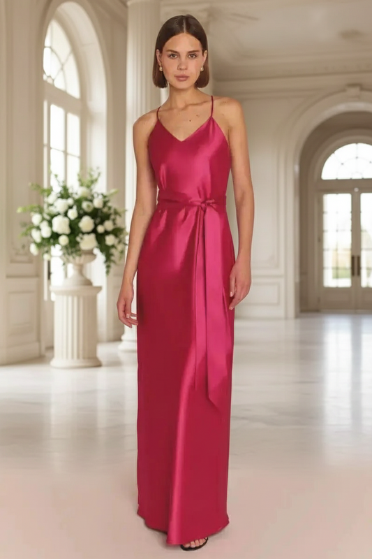 Bridesmaid wearing a pink satin dress in an elegant indoor wedding venue