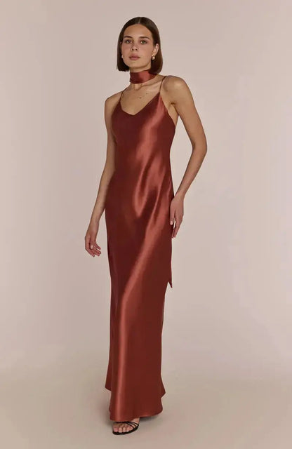 Bridesmaid wearing a terracotta brown bridesmaid satin dress against a beige background