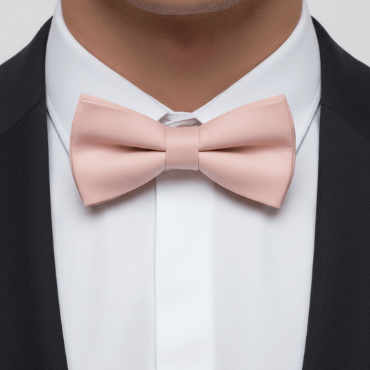 Pink bow tie worn with a black suit and white shirt