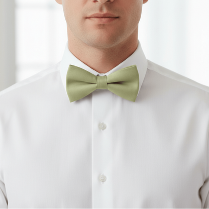 Man wearing a light green bow tie and white shirt against a plain background